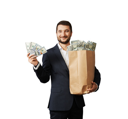 successful businessman holding money and smiling. isolated on white backgroundの写真素材