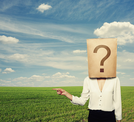 businesswoman with big question pointing at copyspaceの写真素材