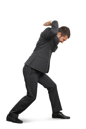 young businessman holding heavy empty copyspace and looking down. isolated on white backgroundの写真素材