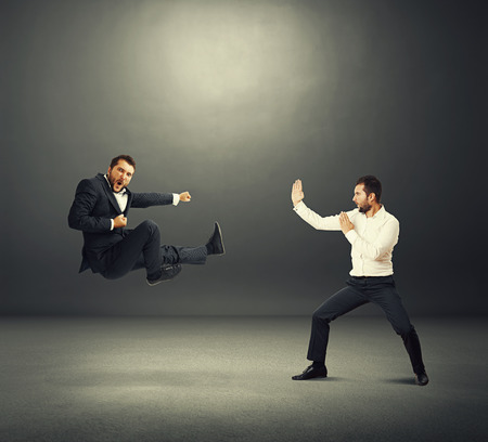 two business fighters over dark backgroundの写真素材