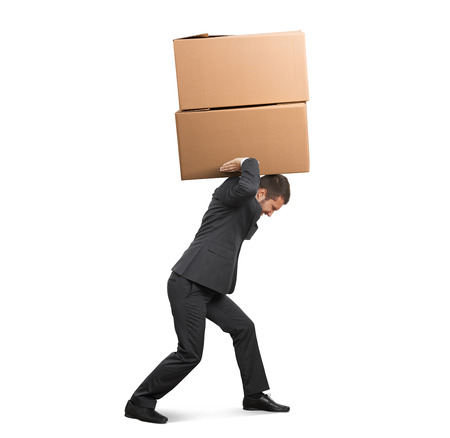 tired businessman carrying two heavy boxes. isolated on white backgroundの写真素材