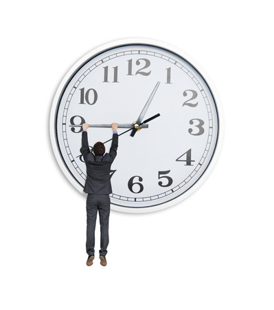 man in black suit hanging at clock hand over white backgroundの写真素材