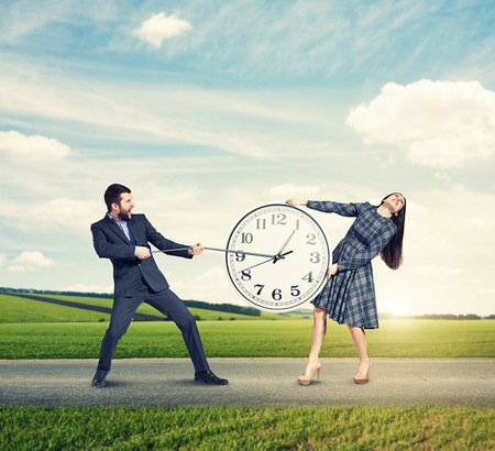 emotional couple with clock at outdoorの写真素材