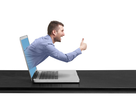 excited man got out of the laptop and showing thumbs up against white backgroundの写真素材