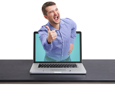 laughing happy man got out of the laptop against white backgroundの写真素材