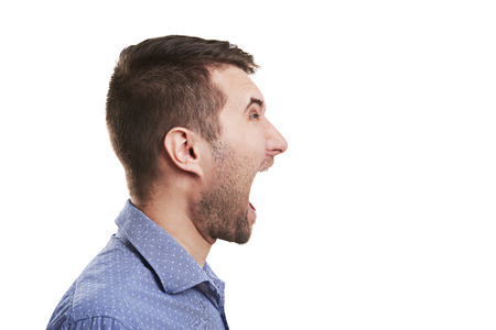 sideview of young man with open mouth. isolated on white background