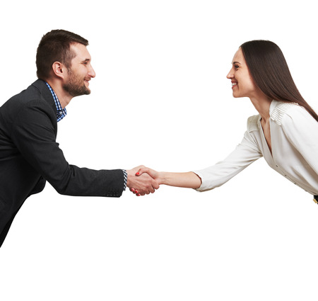 smiley woman and man shaking hands and looking at each other. isolated on white backgroundの写真素材