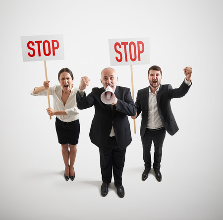 view from above of displeasure people on the meeting with placards and megaphone over light grey backgroundの写真素材