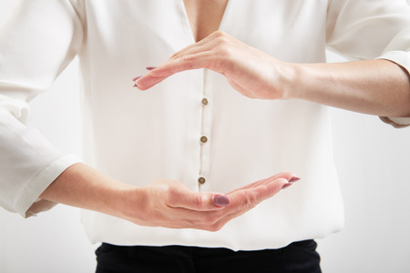 Caucasian woman holding hands like holding somethingの写真素材