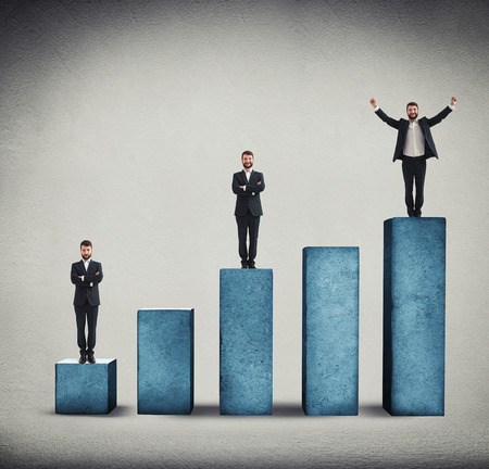 sad, smiley and happy men standing on graph made from concrete over grey backgroundの写真素材