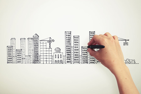 female hand drawing city on the paperの写真素材