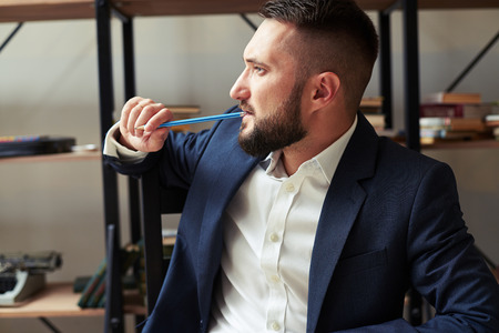 portrait of thoughtful young businessman in officeの写真素材