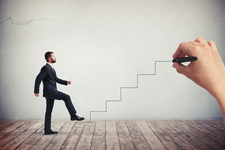 Businessman in a formal wear climbing drawn stairs, side viewの写真素材