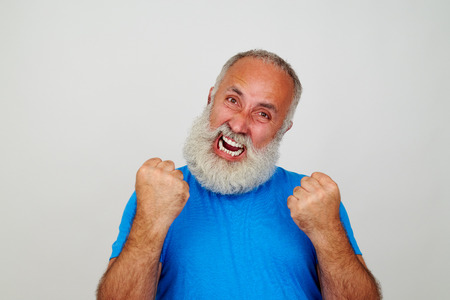 Aged man with white beard is gesturing nervousness isolated on whiteの写真素材