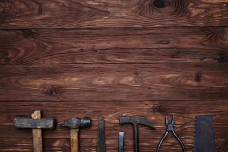 Close-up of old hand tools with copy space isolated on a wooden background