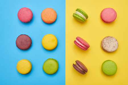 Tasty collection of confection lying on a blue flatlay. Tasty colorful macaroonsの写真素材