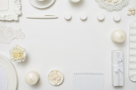 Overhead shot of a stylized desktop with notebook on white backgroundの写真素材