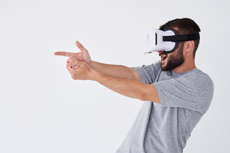 Close-up shot of adult bearded man playing in VRG a game and making gestures with hands as if using...