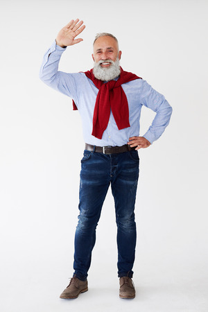 Full-length shot of happy man showing greeting gesture against white backgroundの写真素材