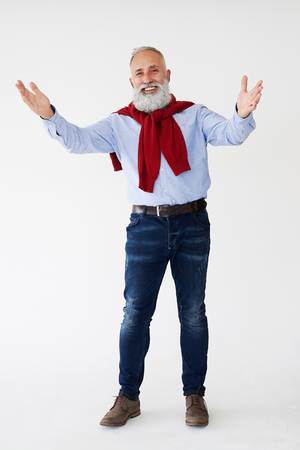 Full-length shot of happy man showing greeting gesture against white backgroundの写真素材