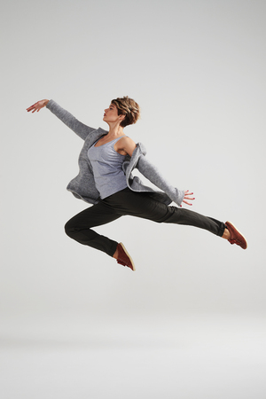 Full-length shot of passionate modern dancer woman working out at studioの写真素材
