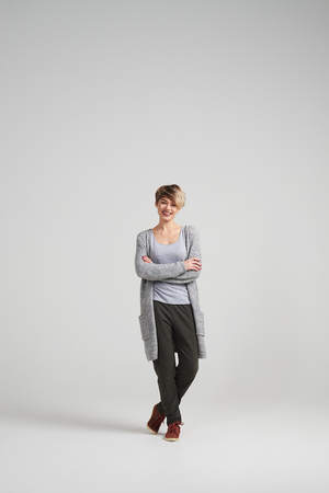 Full-length shot of young woman in casual clothes posing at studioの写真素材
