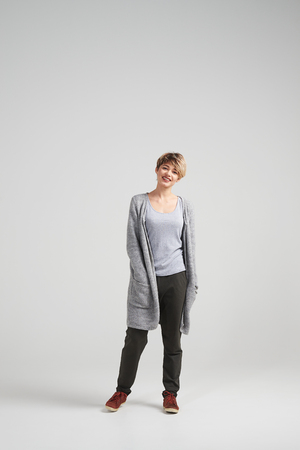 Full-length shot of woman with bob haircut styling posing at cameraの写真素材