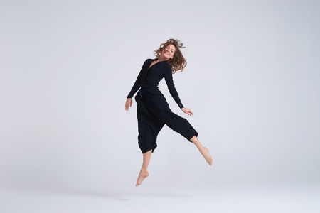 Full-length shot of cheerful young woman hovering in the airの写真素材