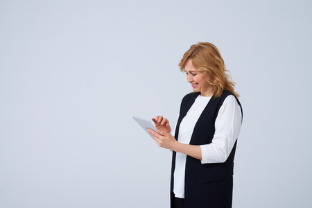 landscape photo of smiley mature blond with digital tabletの写真素材