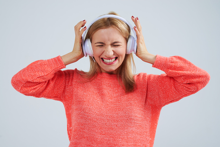 blond in headphones listening bad musicの写真素材