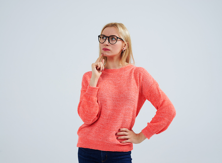 thoughtful young blond in glassesの写真素材