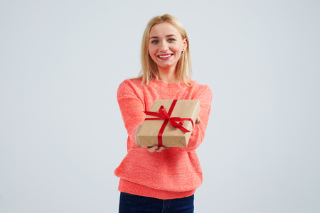 woman smiling and holding gift boxの写真素材