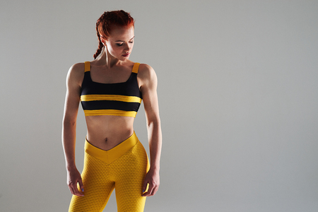 young woman in sportswear posing in studioの写真素材