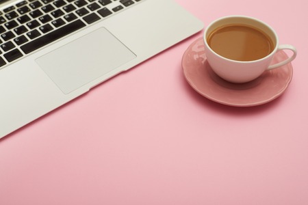 Feminine workplace with laptop and cup of coffeeの写真素材