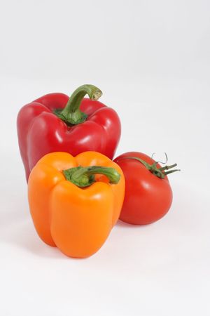 Red both orange sweet pepper and bright red tomatoの写真素材