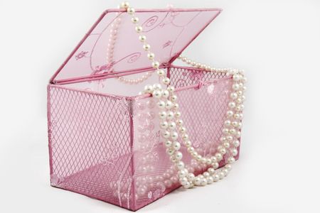 Pink fabric casket for jewelry or cosmetics and a beads from artificial pearlsの写真素材