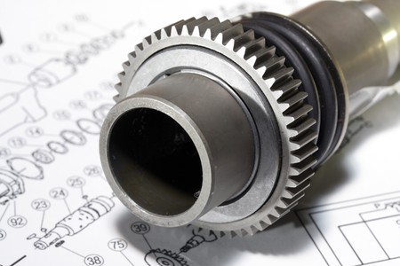 The metal detail - a rotor - lies on the drawingの写真素材