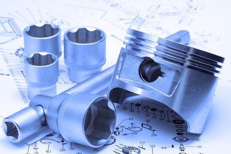 Piston, key, heads lay on plan, blue emphasizes industrial orientation of photoの写真素材