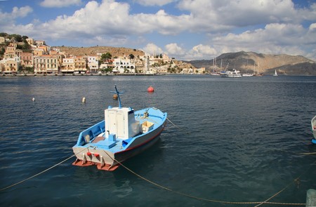 Boat on output from bay, island Symi, mediterranean sea