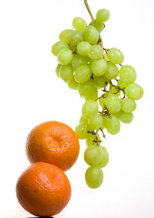 Bunch of grapes in drops of water and tangerinesの写真素材
