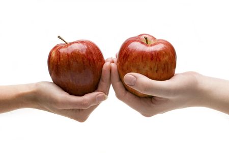 Two hands stretch each other applesの写真素材
