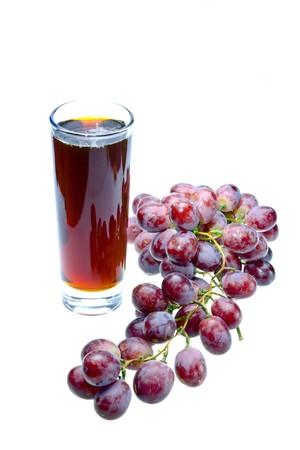 Grape cluster and juice in glassの写真素材