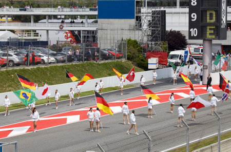 BARCELONA - MAY 9: Girls leave with flags in honour of participants, autodrome Catalunya Montmello...