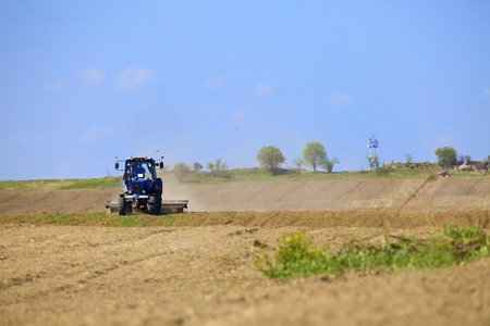 Tractor works in the fieldの写真素材