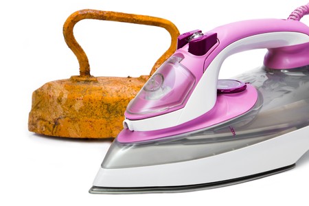 Old rusty pig-iron iron and modern new electric iron on white backgroundの写真素材