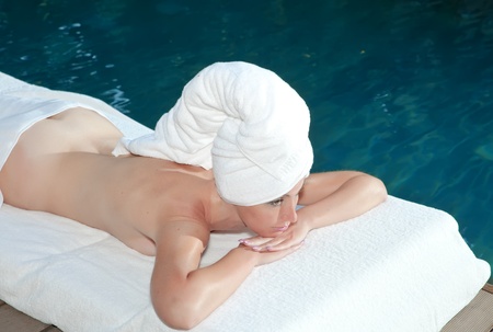 The young beautiful woman on Spa procedures in poolの写真素材