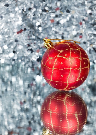 Red New Year's ball on an abstract silvery backgroundの写真素材