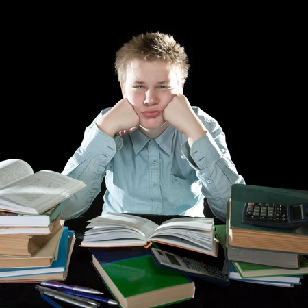 The teenager with a heap of textbooksの写真素材