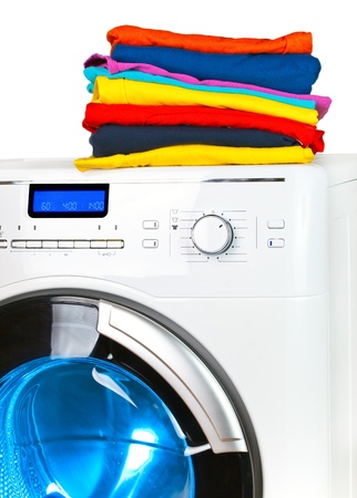 Pile of colorful clothes on the washing machineの写真素材