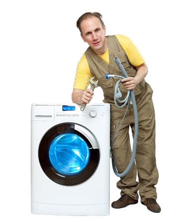 The repairman near the washing machineの写真素材